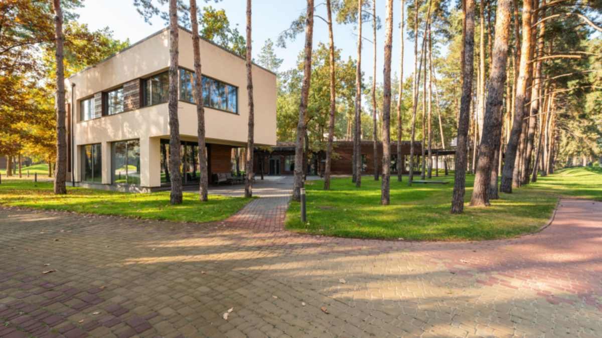 Senior living community building among pine trees, senior living insurance