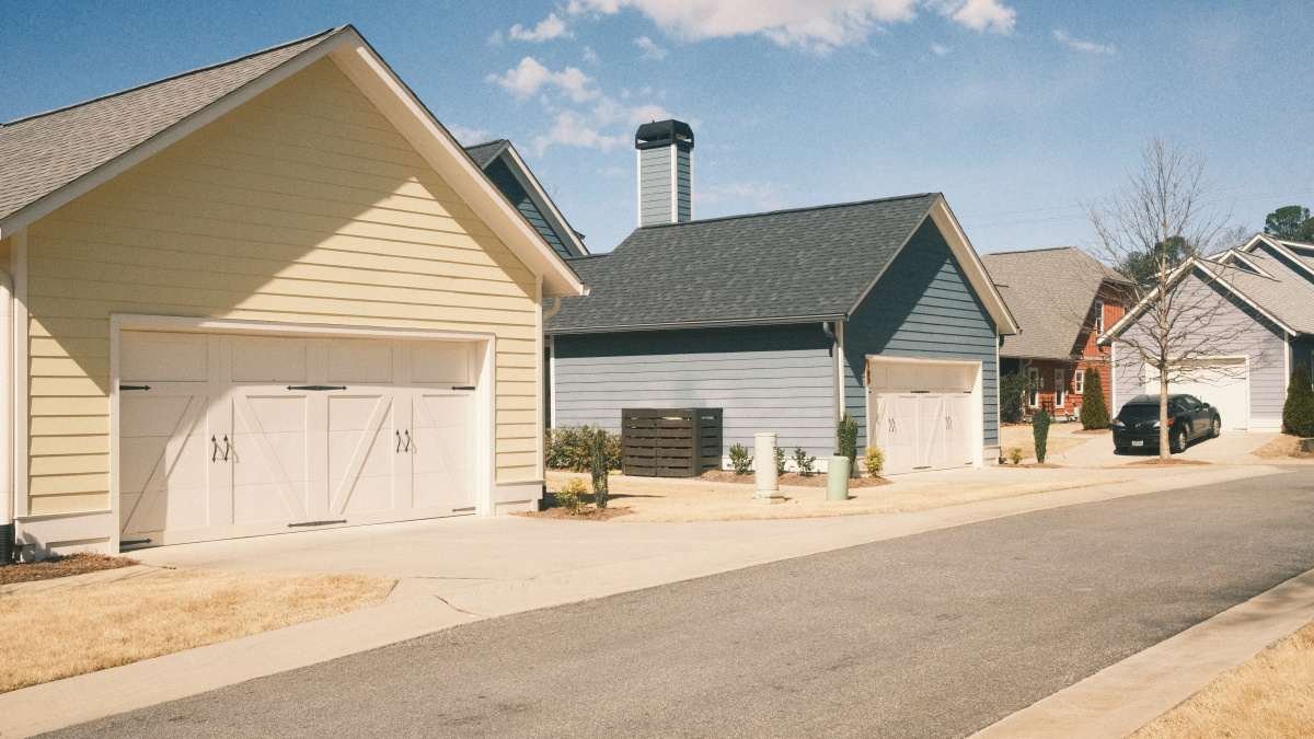 Street of new single-family homes with garages, build-to-rent insurance