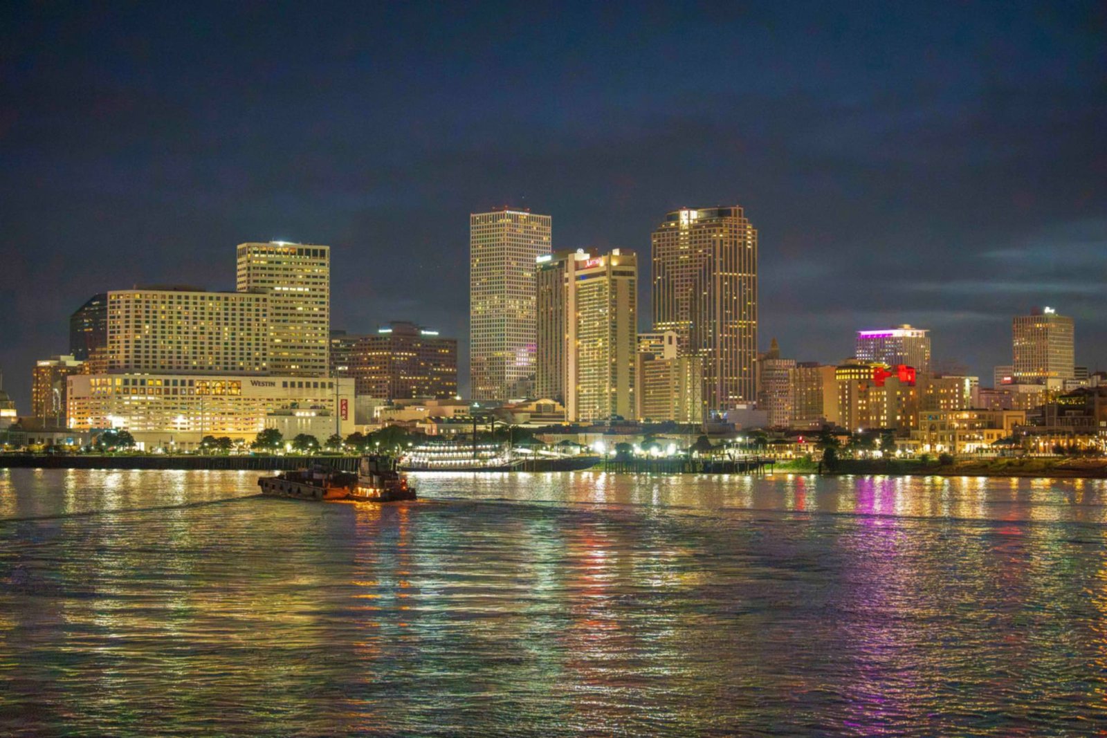 New Orleans skyline over the Mississippi River at night, Louisiana commercial property insurance