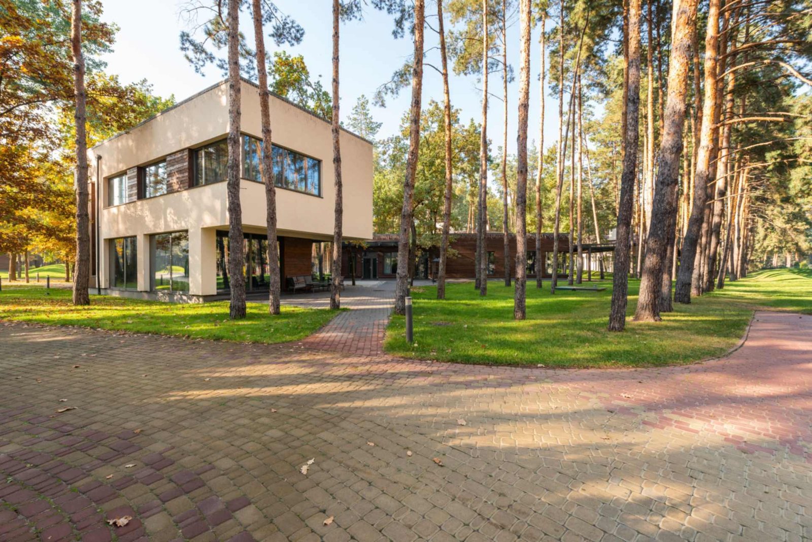 Senior living community building among pine trees, senior living insurance