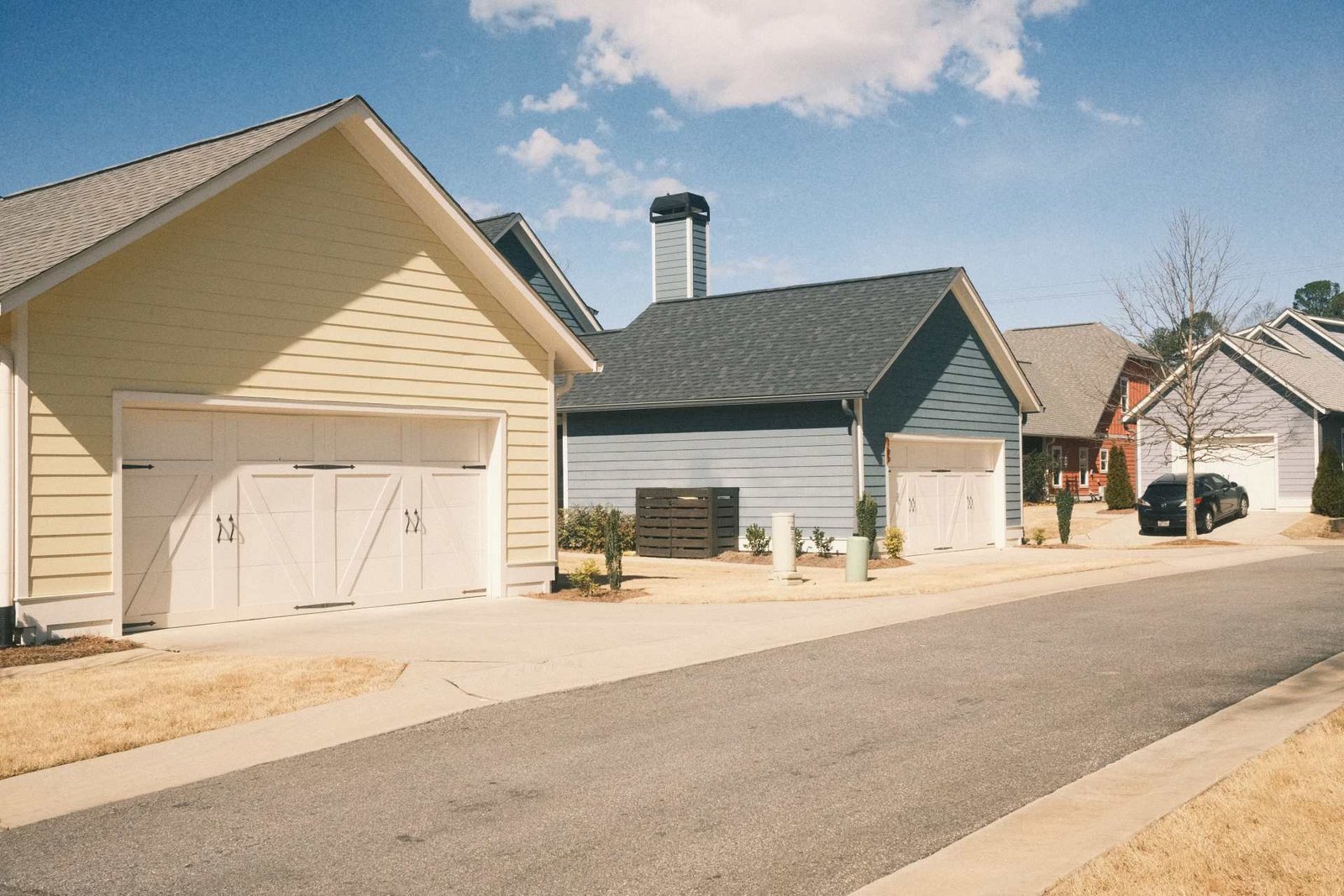 Street of new single-family homes with garages, build-to-rent insurance
